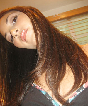 18 year old girl Katie Lewis stands naked after undressing in her bedroom