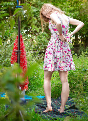 18 year old girl Katie Lewis stands naked after undressing in her bedroom